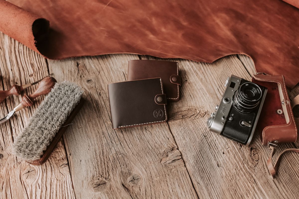An open leather bifold wallet showing its saddle stitching